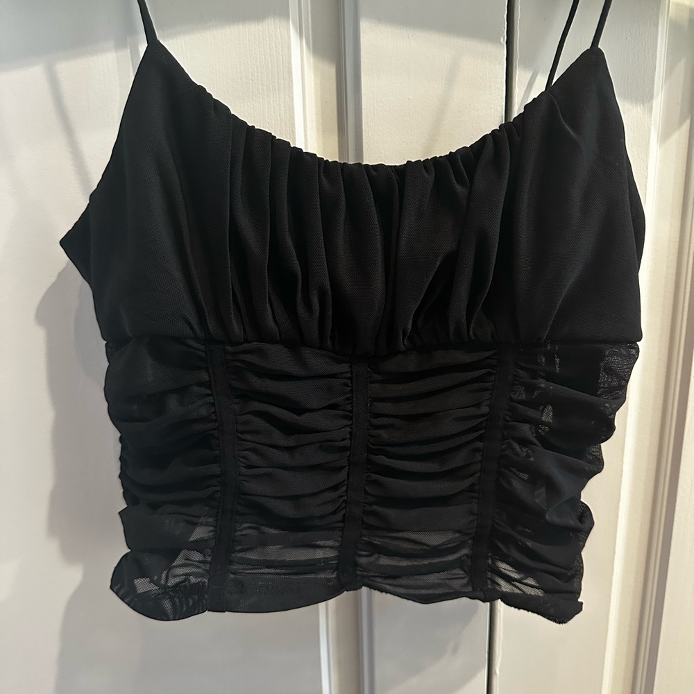 Black mesh spaghetti strap tank top with zipper on the side.